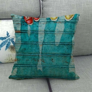 Close-up of linen cushion cover featuring artistic painted jeans and sneakers pattern