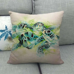 Detailed view of linen cushion cover with watercolor sea turtle print on grey fabric sofa