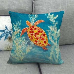 Detailed close-up of a linen cushion cover with an artistic orange sea turtle pattern