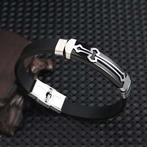 Detailed close-up of a men's black silicone bracelet with a stainless steel cross motif