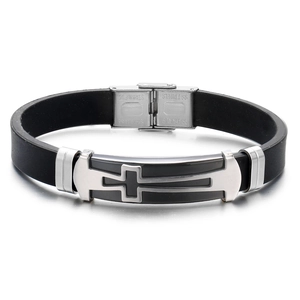 Detail of men's cross bracelet with black silicone band and stainless steel clasp