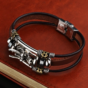 Detail view of the vintage dragon head charm and industrial metal beads on the leather strap