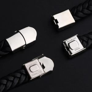 Detail of silver stainless steel clasp mechanism on black braided leather bracelet