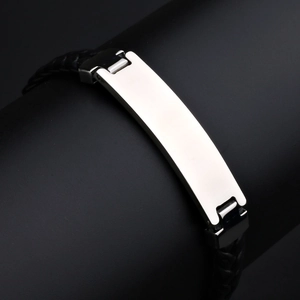 Macro shot of black braided leather strap and silver stainless steel ID metal tag