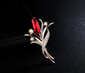 Macro view of crystal flower brooch with large red stone and rhinestones on black leather
