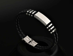 Detailed close-up of men's silicone wristband with stainless steel plate and folding clasp