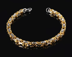 Detail of bicolor gold and silver Byzantine chain bracelet with lobster clasp on black background