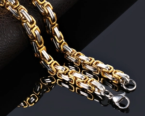 Detailed close-up of heavy Byzantine steel chain with two-tone finish and lobster clasp