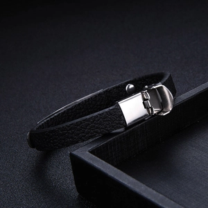 Close-up of black litchi grain leather bracelet with silver stainless steel folding clasp