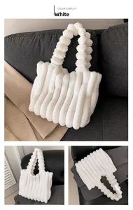 Detail view of white plush tote bag featuring soft ribbed texture and faux fur handle