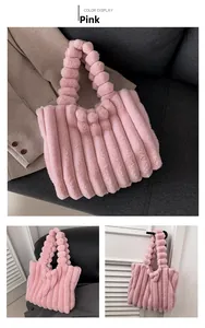 Detail view of pink plush tote bag with vertical pleated faux fur and soft ball handle