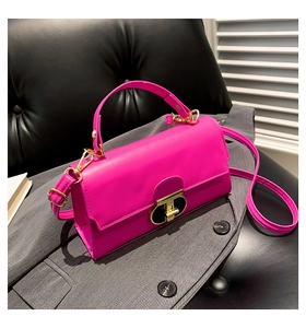 Detailed view of magenta PU leather square bag with golden T-shaped metal lock