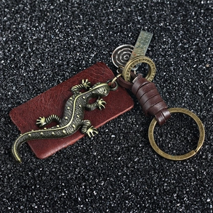 Vintage bronze gecko keychain with braided leather strap and engraved metal charm
