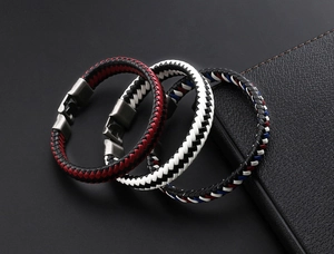 Detailed close-up of three braided leather bracelets with secure metal clasps in various colors