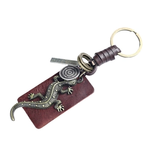 Vintage bronze lizard keychain with braided brown leather strap and engraved metal charms