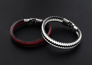Close-up of dual woven leather bracelets in red, black and white with silver alloy buckles