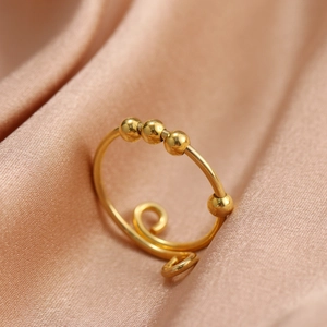 Detailed macro view of gold plated 925 silver stress relief ring with four movable beads