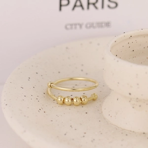 Adjustable golden anxiety spinner ring with movable beads for stress relief and elegance