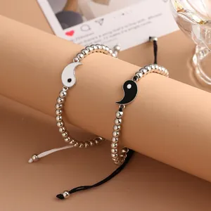 Pair of Tai Chi Yin Yang beaded bracelets with adjustable braided cords for couples