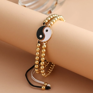 Pair of beaded Yin Yang bracelets with gold-plated beads and woven cords for couples