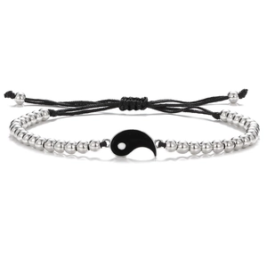 Detail view of woven Tai Chi Yin Yang bracelet with silver beads and adjustable black cord
