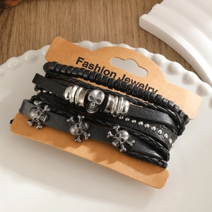Vintage black leather braided bracelet set with skull charms on display card