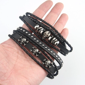 Men's retro leather bracelet set with skull charms and metallic studs on braided cord