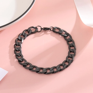 Detailed close-up of a black stainless steel Cuban curb chain bracelet with lobster clasp