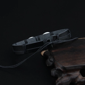 Handmade black leather woven shell bracelet with adjustable Hawaiian tribal style cord