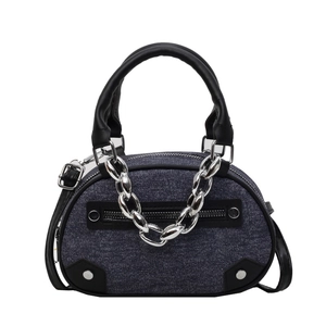 Minimalist denim handbag with black leather trim and silver metal chain detail