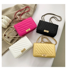 Detail of four colorful quilted crossbody bags with gold chain straps and metal twist locks