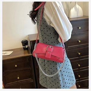 Detail view of pink PU leather shoulder bag with silver buckle and metal chain strap