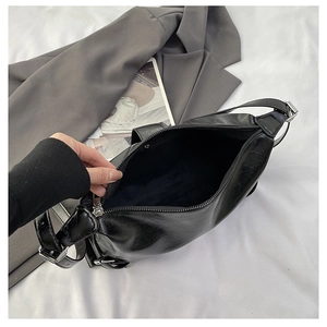 Detail of black vintage leather bag with zipper opening and spacious interior compartment