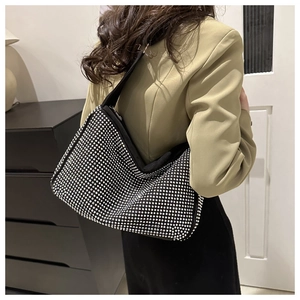 Close-up of a black rhinestone hobo bag showing the sparkling diamond mesh texture
