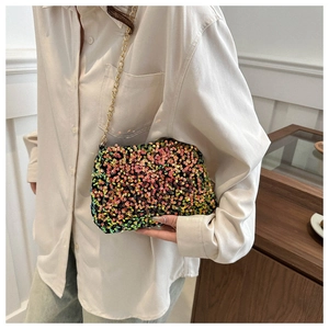 Detail of colorful sequins and golden chain strap on a rectangular party clutch bag