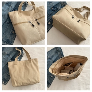 Détails du grand sac cabas en toile montrant les compartiments internes et poches zippées