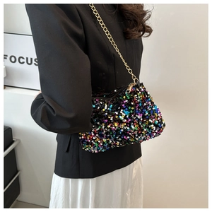 Close-up of a colorful sequin crossbody bag with a golden metal chain strap detail