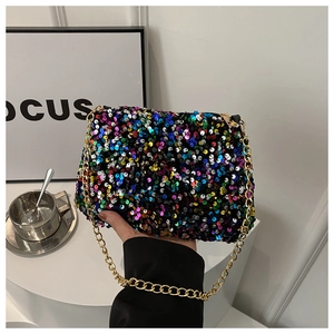 Close-up of colorful sequins and gold chain strap on a trendy square shoulder bag