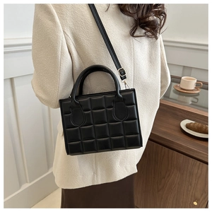 Quilted black crossbody bag styled with a neutral lifestyle background for daily wear