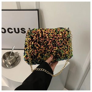 Detailed view of shimmering sequins and gold chain strap on a stylish crossbody bag