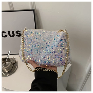 Close-up of white sequins shoulder bag with colorful iridescent shine and gold chain