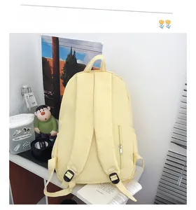 Detail of yellow canvas backpack with thickened shoulder straps and hidden side zipper pocket