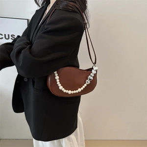 Brown semi-circular underarm bag with decorative pearl and silver heart chain