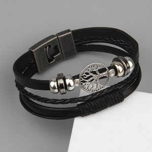 Detail of multi-layer leather bracelet with Tree of Life charm and vintage metal clasp
