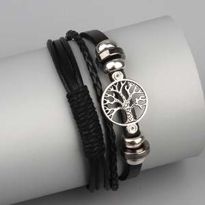 Detail of vintage layered leather bracelet featuring a silver Tree of Life charm for men