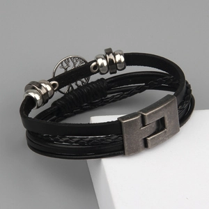 Detail of multi-layer leather bracelet with Tree of Life pendant and metal clasp