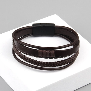 Detail of multi-layer braided leather bracelet with a matte black magnetic clasp