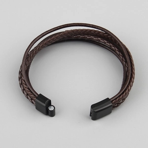 Detail of dark brown multi-layer braided leather bracelet with black matte magnetic clasp