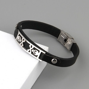 Men's punk black leather bracelet featuring silver skull charms and stainless steel clasp