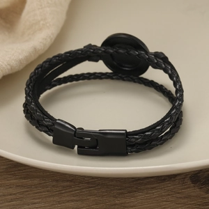 Handmade woven black leather bracelet for men with rugby style design and secure buckle clasp